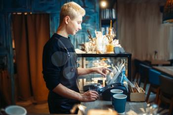 Barista hand pours beverage from coffee machine. Professional espresso preparation by bartender