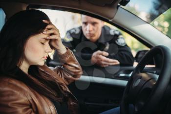 Male cop in uniform check female driver on the road. Law protection, car traffic inspector, safety control job