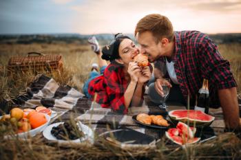 Love couple leisure together, picnic on the meadow. Romantic junket, man and woman on outdoor dinner,  happy family weekend