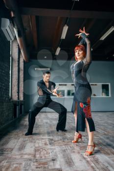 Elegance couple on ballrom dance training in class. Female and male partners on professional pair dancing in studio