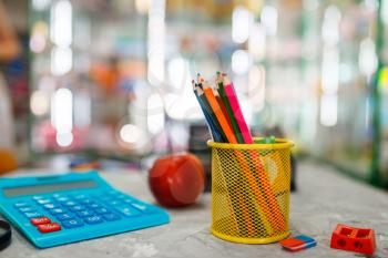 Office supplies on the table in stationery store, nobody. assortment in shop, rows of accessories for drawing and writing, school equipment