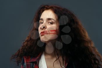 Young woman's face crushed on transparent glass, girl with smeared lipstick. Female person standing at the showcase with uncomfortable looking, humor, emotion expression