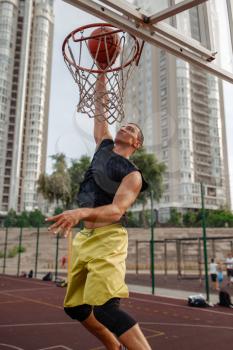 Basketball ball hits the basket outdoor, nobody. Streetball sport, game concept