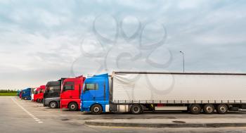 Trucks on parking, cargo transportation in European cities. Vehicles for for delivery of goods in Europe