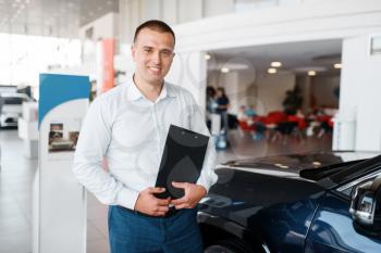 Salesman shows new car in showroom. Male customer buying vehicle in dealership, automobile sale, auto purchase