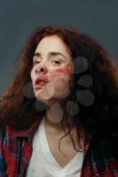 Young woman's face crushed on transparent glass, girl with smeared lipstick. Female person standing at the showcase with uncomfortable looking, humor, emotion expression