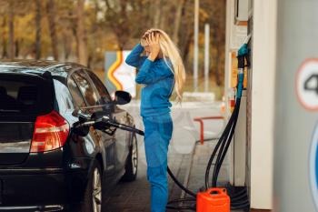 Stressed woman on gas station, fuel filling. Petrol fueling, gasoline or diesel refuel service, high price on petroleum