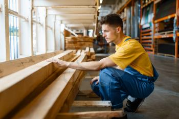 Male builder choosing repair materials in hardware store. Customer look at the goods in diy shop