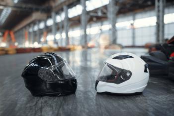 Two go kart helmets on the ground, karting auto sport concept. Speed racing go-kart track. Fast vehicle competition, hot pursuit