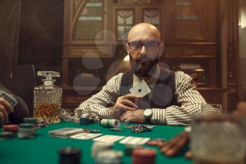 Bearded poker player show ace card, casino. Games of chance addiction. Man leisures in gambling house, gaming table