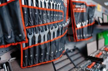 Showcase with wrenches kits in tool store closeup, nobody. Choice of equipment in hardware shop, professional instrument in supermarket