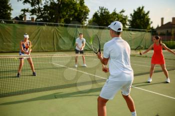 Mixed doubles tennis training, outdoor court. Active healthy lifestyle, people play sport game with racket and ball, fitness workout with racquets