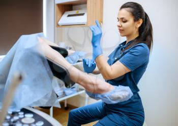 Female gynecologist in gloves and uniform and patient in chair, Gynecological examination in clinic, gynecology diagnostic or consultation, exam