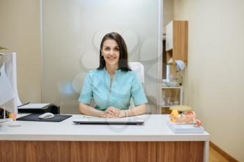 Female gynecologist sitting at the table in clinic. Gynecological examination or consultation, gynecology office. Doctor in hospital