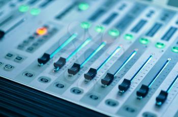 Mixing console closeup, studio and concert equipment, nobody. Professional audio mixer panel, sound engineer or musician workplace, soundboard