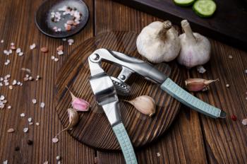 Fresh garlic on board on wooden background. Organic vegetarian food, grocery assortment, natural products, healthy lifestyle concept