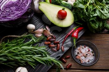 Fresh vegetables and bean closeup, on wooden background. Organic vegetarian food, grocery assortment, natural products, healthy lifestyle concept