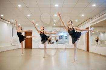 Three young ballerinas, teens rehearsing in class. Ballet school, female dancers on choreography lesson, girls practicing grace dance