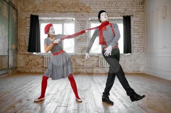 Male and female mime artists, strangulation with a scarf parody scene, comedy. Pantomime theater, comedian, positive emotion, humour performance, funny face mimic and grimace