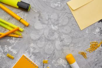 Office stationery supplies in yellow tones closeup, marble background. School or education accessories, writing and drawing tools, pencils and rubbers, ruler and paper clips