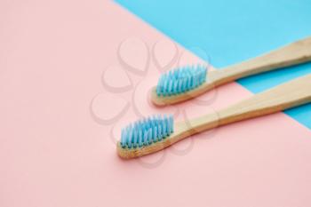 Oral care products concept, blue background, nobody. Morning healthcare procedures concept, toothcare, two toothbrushes