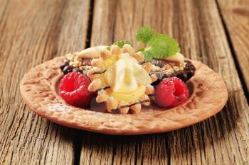 Chocolate and vanilla cream tartlets garnished with raspberries