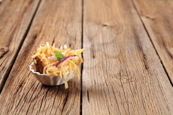 Baked potato sprinkled with grated cheese and onion