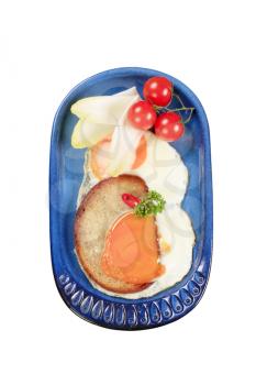 Fried egg and bread with vegetable garnish