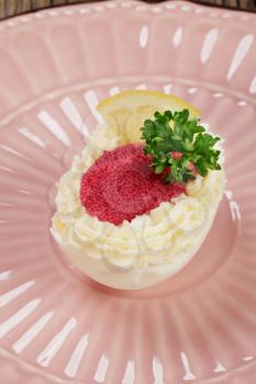Egg white stuffed with savory spread and red caviar