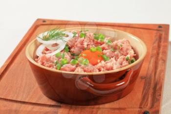 Ground meat and other ingredients in a ceramic pot