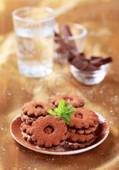 Cream-filled chocolate sandwich cookies dusted with cocoa powder