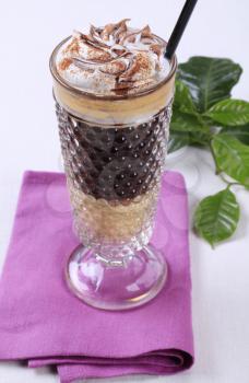 Liqueur coffee with whipped cream and chocolate sauce