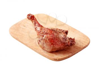 Roast leg of duck on a chopping board