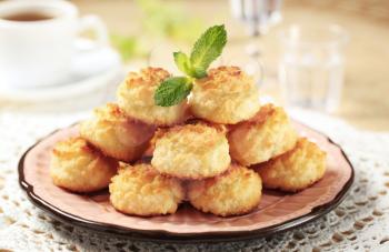 Stack of coconut macaroons on a decorative plate