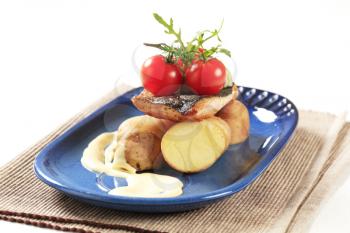 Pan fried fish served with new potatoes