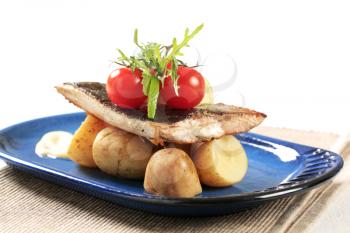 Pan fried fish fillet served with new potatoes 