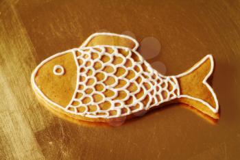 Closeup of gingerbread fish on a golden plate