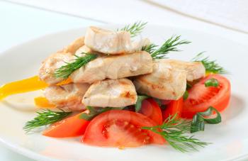 Seared chicken breast pieces with vegetables and dill