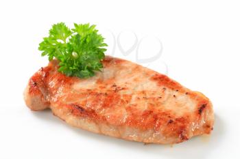 Pan seared pork cutlet isolated on white