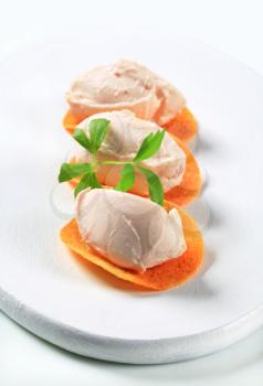 Ham or salmon mousse on spicy crisps
