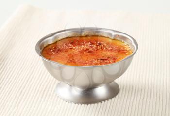 Creme brulee in a metal serving dish