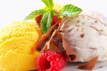 Scoops of ice cream with chocolate curls and fruit