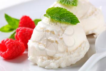 Scoops of creamy ice cream with fresh raspberries