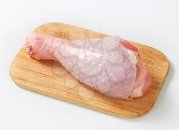 Raw turkey leg on cutting board