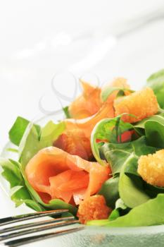 Salad greens with smoked salmon and croutons