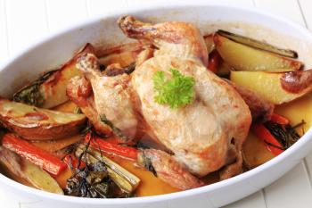 Chicken with potatoes , carrot and celery baked in a casserole dish