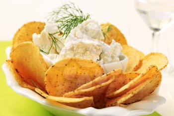 Bowl of tortilla chips and curd cheese