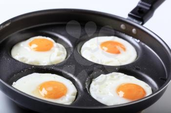 Four fried eggs on a pan - Sunny side up 