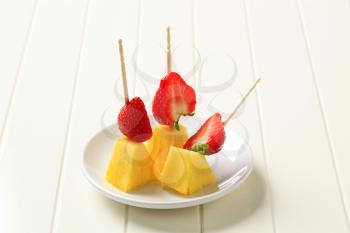 Fresh pineapple and strawberries on cocktail sticks