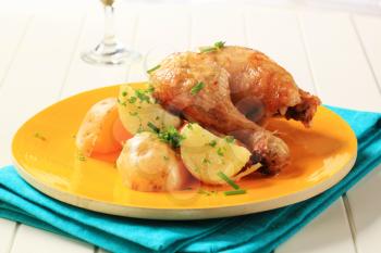 Roasted chicken and potatoes sprinkled with chives and parsley